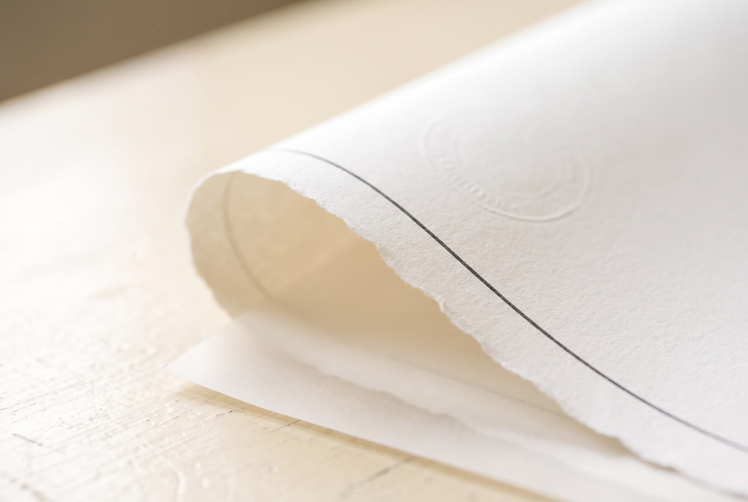 Macro of layered legal paper and vellum with a blind-embossed seal — the records a title file is built from